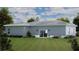 A spacious backyard with a sliding glass door and lush landscaping at 4503 Opel Ter, Port Charlotte, FL 33981