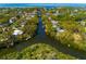 Aerial view of the island located in the middle of waterway surrounded by a green neighborhood with waterfront houses at 4605 W Vasconia St, Tampa, FL 33629