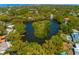 High angle aerial photograph of residential area with waterfront and an island covered with trees and vegetation at 4605 W Vasconia St, Tampa, FL 33629