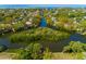Aerial view of the island located in the middle of waterway surrounded by a green neighborhood with waterfront houses at 4605 W Vasconia St, Tampa, FL 33629