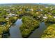 High angle captures a residential area enveloping a lake and an island covered with trees and vegetation at 4605 W Vasconia St, Tampa, FL 33629