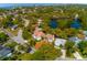 Breathtaking aerial view showcasing lush neighborhood with a serene lake, coastal views, and beautiful homes at 4605 W Vasconia St, Tampa, FL 33629