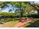 Landscaped backyard with a brick patio, fire pit, view of the bayou, and access to the water at 4605 W Vasconia St, Tampa, FL 33629