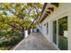 Large balcony with stone tile and wrought iron railing has a view of the mature trees at 4605 W Vasconia St, Tampa, FL 33629