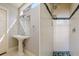 Bathroom featuring pedestal sink and tiled walk-in shower with a decorative green border at 4605 W Vasconia St, Tampa, FL 33629