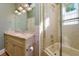 Bathroom featuring single sink vanity, tiled shower with glass doors and cream colored walls at 4605 W Vasconia St, Tampa, FL 33629