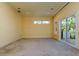 Bright bedroom with carpet floor and sliding glass doors to the outdoor balcony with a beautiful backyard view at 4605 W Vasconia St, Tampa, FL 33629