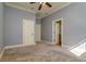 Spacious bedroom features neutral carpet, light blue walls, ceiling fan, and white trim at 4605 W Vasconia St, Tampa, FL 33629