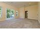 Well-lit bedroom with carpet floor and sliding glass doors to the outdoor balcony with a beautiful backyard view at 4605 W Vasconia St, Tampa, FL 33629