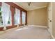 Bright, unfurnished bedroom with three large windows with sheer white curtains at 4605 W Vasconia St, Tampa, FL 33629