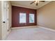 Empty bedroom with dual-paned windows and neutral colored walls and carpet at 4605 W Vasconia St, Tampa, FL 33629