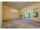 Bright bedroom with carpet floor and sliding glass doors to the outdoor balcony with a beautiful backyard view at 4605 W Vasconia St, Tampa, FL 33629