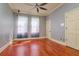Bedroom with a ceiling fan, cherry wood floors, natural light, and two closets at 4605 W Vasconia St, Tampa, FL 33629