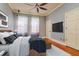 Well-lit bedroom with hardwood floors, a large window, and comfortable bed at 4605 W Vasconia St, Tampa, FL 33629