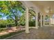 A spacious covered patio featuring columns and a brick firepit, perfect for outdoor entertainment at 4605 W Vasconia St, Tampa, FL 33629