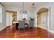 Bright dining room with neutral paint, cherry wood floors, and a modern chandelier at 4605 W Vasconia St, Tampa, FL 33629