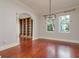 Empty living room with cherry wood floors, large windows and decorative lighting at 4605 W Vasconia St, Tampa, FL 33629