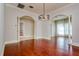 Empty room with decorative lighting, cherry wood floors and archways at 4605 W Vasconia St, Tampa, FL 33629