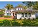 Elegant two-story home featuring a red front door, decorative windows, and a well-manicured lawn at 4605 W Vasconia St, Tampa, FL 33629