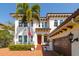 Beautifully maintained home with an attached garage, palm tree, and lush greenery, creating a serene setting at 4605 W Vasconia St, Tampa, FL 33629