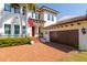 Attractive home with a brick driveway leading to a garage and an American flag adding character at 4605 W Vasconia St, Tampa, FL 33629