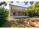 Charming home with a brick patio, fire pit, lush landscaping, and a second story balcony at 4605 W Vasconia St, Tampa, FL 33629