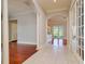 Hallway with tile flooring and views of multiple living spaces through arched entryways at 4605 W Vasconia St, Tampa, FL 33629