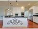 Kitchen showcasing an island with seating, granite counters, and stainless steel appliances at 4605 W Vasconia St, Tampa, FL 33629