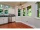 Kitchen area features stainless dishwasher, granite countertops and multiple bright windows at 4605 W Vasconia St, Tampa, FL 33629
