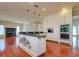 Kitchen island with seating, granite counters, stainless appliances, and open to the living room at 4605 W Vasconia St, Tampa, FL 33629
