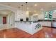 Open kitchen with granite counters, white cabinets, stainless appliances, and pendant lighting at 4605 W Vasconia St, Tampa, FL 33629