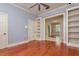 Living room with cherry wood floors, bookcases, and archway to another room at 4605 W Vasconia St, Tampa, FL 33629