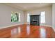Bright living room featuring hardwood floors and a fireplace with views of the yard at 4605 W Vasconia St, Tampa, FL 33629