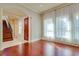 Living Room with hardwood floors, natural light, and view into the foyer with stairs at 4605 W Vasconia St, Tampa, FL 33629
