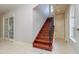 Elegant staircase with hardwood steps and iron railing, leading to the upper level at 4605 W Vasconia St, Tampa, FL 33629