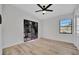 Bright, empty bedroom features hardwood floors, a ceiling fan, and access to the backyard at 4720 50Th N Ave, St Petersburg, FL 33714