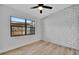 Bright bedroom features a brick accent wall and a large window at 4720 50Th N Ave, St Petersburg, FL 33714