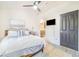 Well-lit bedroom features ensuite bath access, mounted television, and comfortable queen bed at 506 S Willow Ave # 7, Tampa, FL 33606