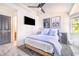 Cozy bedroom with a ceiling fan, a TV, and bright natural light from a window at 506 S Willow Ave # 7, Tampa, FL 33606