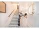 Bright and airy hallway with stairs leading to the upper level, showcasing modern flooring and neutral decor at 506 S Willow Ave # 7, Tampa, FL 33606
