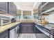Charming kitchen features granite countertops, stainless steel appliances, and a view from the window at 506 S Willow Ave # 7, Tampa, FL 33606