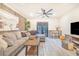 Inviting living room with cozy sectional sofa, rustic wood accents, and a mounted TV at 506 S Willow Ave # 7, Tampa, FL 33606