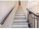 Stairway with gray and white steps leads to the upper level of the home at 506 S Willow Ave # 7, Tampa, FL 33606