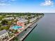 Stunning aerial view of waterfront condos, pool, dock, and Tampa skyline in the distance at 5101 Coquina Key Se Dr # A, St Petersburg, FL 33705