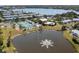 Aerial view highlighting community amenities, including a lake, pool, tennis courts, and residential buildings at 5101 Coquina Key Se Dr # A, St Petersburg, FL 33705