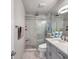 Beautifully renovated bathroom features marble tile, glass shower doors, updated vanity with stylish faucet and modern lighting at 5101 Coquina Key Se Dr # A, St Petersburg, FL 33705