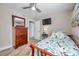 Bedroom featuring ceiling fan, wall-mounted TV, and classic wooden dresser at 5101 Coquina Key Se Dr # A, St Petersburg, FL 33705
