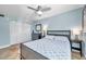 Relaxing bedroom featuring a ceiling fan, tile floor, closet, blue walls, and lamps on side tables to light the room at 5101 Coquina Key Se Dr # A, St Petersburg, FL 33705