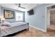 Bedroom featuring tile floor, a TV on the wall and a view to the bathroom through a doorway to the side at 5101 Coquina Key Se Dr # A, St Petersburg, FL 33705