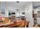 Open dining area flows into a living room and kitchen, with a tile-topped table and seating at 5101 Coquina Key Se Dr # A, St Petersburg, FL 33705